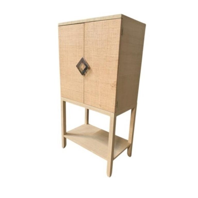 Designed by Wildwood natural raffia. The inside of the cabinet features a mirrored back, rack for 12 wine glasses, shelf...