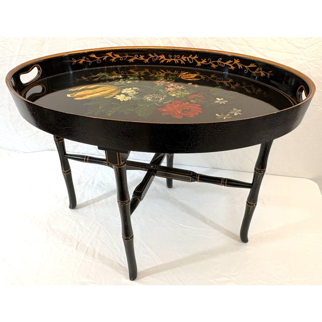 Beautifully crafted Regency Chinoiserie style tray table from the late 20th century. It is made of wood with hand painted...