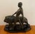 A rare Art Deco patinated metal sculpture modelled as an athletic male walking alongside a stylized lion. The work is set...