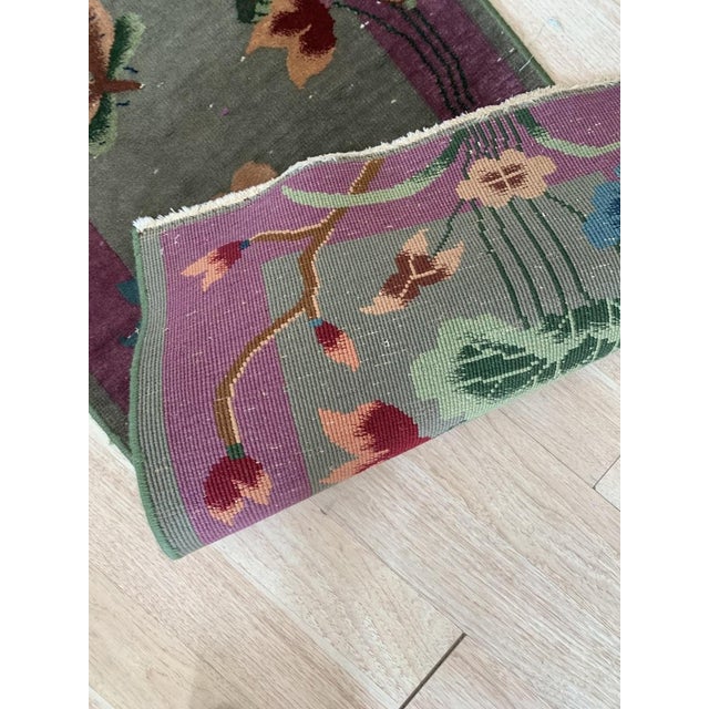 Experience the elegance of the 1920s with this handmade antique Chinese Art Deco rug, a stunning representation of early...
