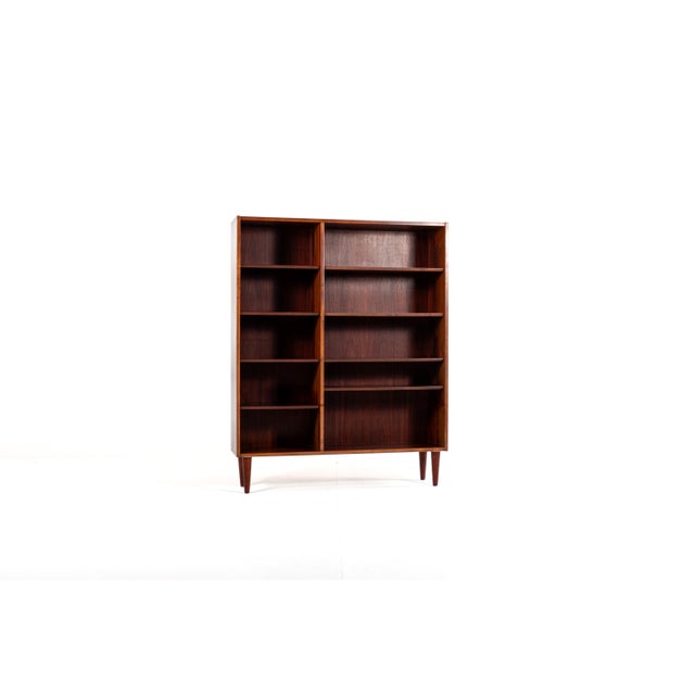 This elegant Danish bookcase is made of beautiful rosewood veneer (Bolivian rosewood) with a deep, warm colour and...