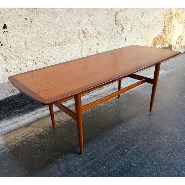 Very handsome example of Mid-Century Swedish Modern design in this vintage teak coffee table, crafted by noted furniture...