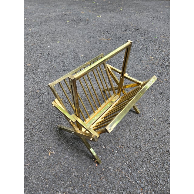 Italian Hollywood Regency Mid-Century ( probably 70s) magazine rack in a patinas squared brass framing. Folding and...