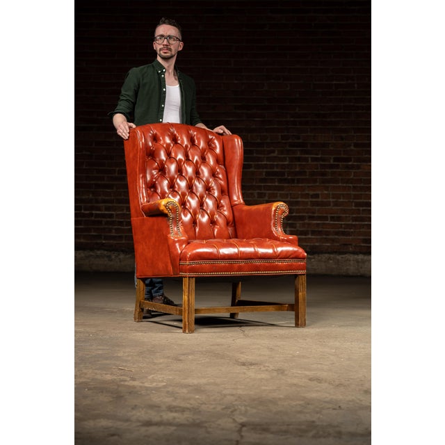 Vintage tufted leather chair and ottoman set. Stylishly distressed, this piece features an all-over orange gradient with a...