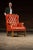 Vintage tufted leather chair and ottoman set. Stylishly distressed, this piece features an all-over orange gradient with a...