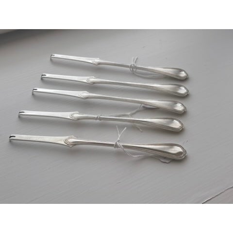 Set of five silverplate lobster picks by Christofle, Paris. Each bears the C C poinçon with balance scales, Christofle's...