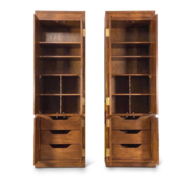 Pair of solid wood Henredon Scene One collection campaign cabinets. The intricate design in hardware and versatility of...