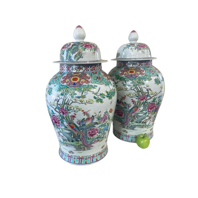This outstanding Chinoiserie pair of Famille Rose porcelain ginger jars comes with a vivid pair of phoenixes/cranes,...