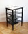 A refined late 1940s Czechoslovak Modernist étagère or occasional table, constructed from slender black-painted timber...