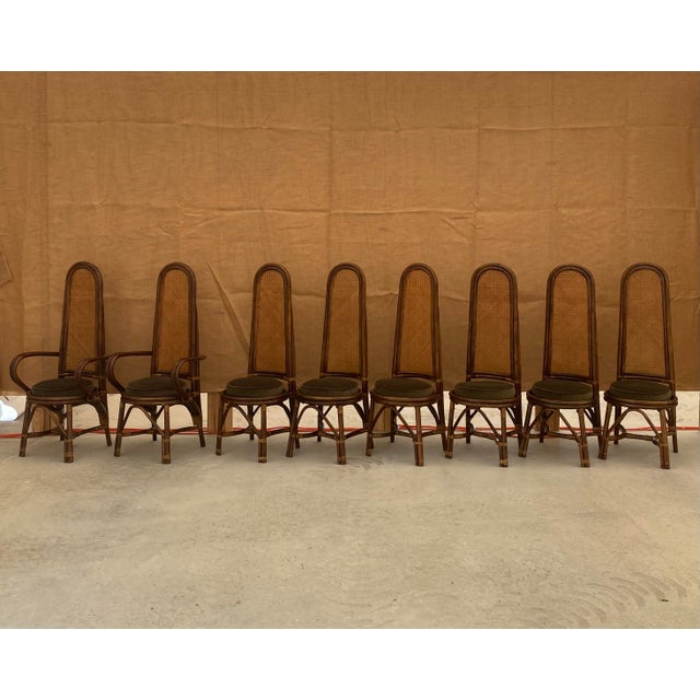 Unusually proportioned rattan and hand-caned dining chairs in an extra large, full set of eight. The set consists of six...