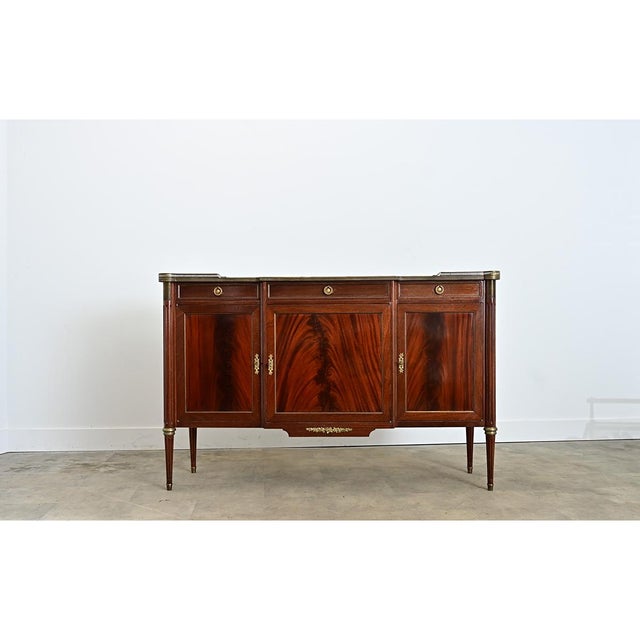 An elegant storage piece for a dining room or foyer, this 20th century Louis XVI style enfilade captures the refinement of...
