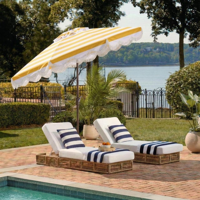 Transform your outdoor space into a stylish haven with the Lucerna 9 ft crank umbrella. Sporting a vibrant yellow stripe...