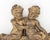 Belle Epoque Style Pair of Cherubs Gilt Plaster Applique, the two nude figures seated atop drapery and flowers. 14" H x...
