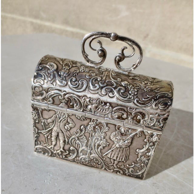 Antique German silver cask for jewelry or keepsakes. Cast silver with a hinged lid and decorated by a male and female...