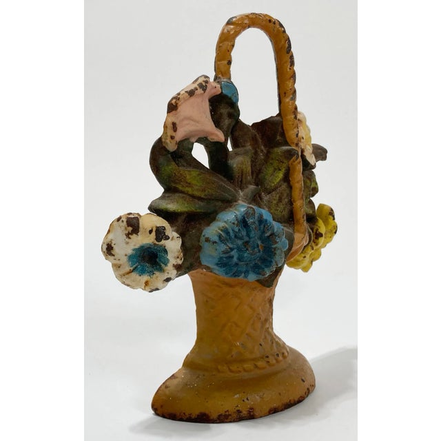 Charming and colorful vintage Hubley cast iron doorstop showing a bouquet of flowers in a woven basket. Retains the...