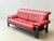 A striking vintage sofa by ligne roset featuring a bold combination of red smooth leather and a solid, black-painted...