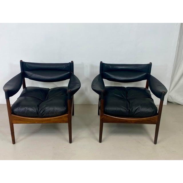 Pair of Modus armchairs in black leather and rosewood, designed by Kristian Vedel for Søren Willadsen Møbelfabrik. Made in...