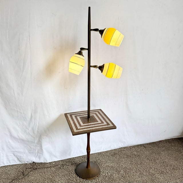 This striking Mid-Century Modern atomic-style floor lamp seamlessly blends sculptural lighting with functional design....