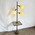 This striking Mid-Century Modern atomic-style floor lamp seamlessly blends sculptural lighting with functional design....