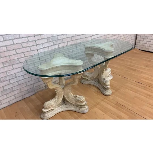 Vintage Neoclassical Faux-Stone Dolphin Pedestal Table with Glass Top Vintage table featuring a shaped glass top supported...