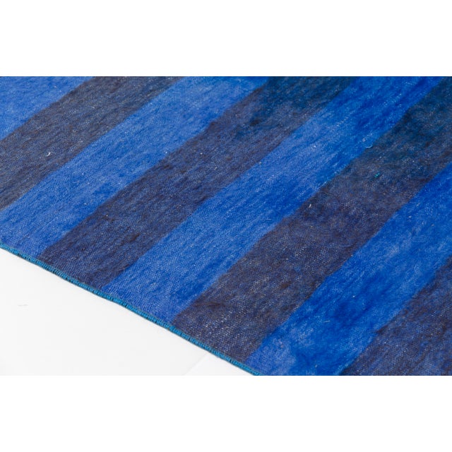 This is a vintage Turkish Oushak rug from the Mid 20th Century. The piece was hand-knotted.