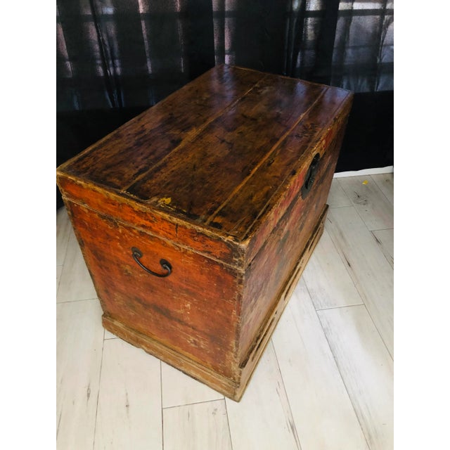 Timeless Ming Trunk. Rich natural patina painted red & black on light wood, original iron hardware. Beautiful coffee table...
