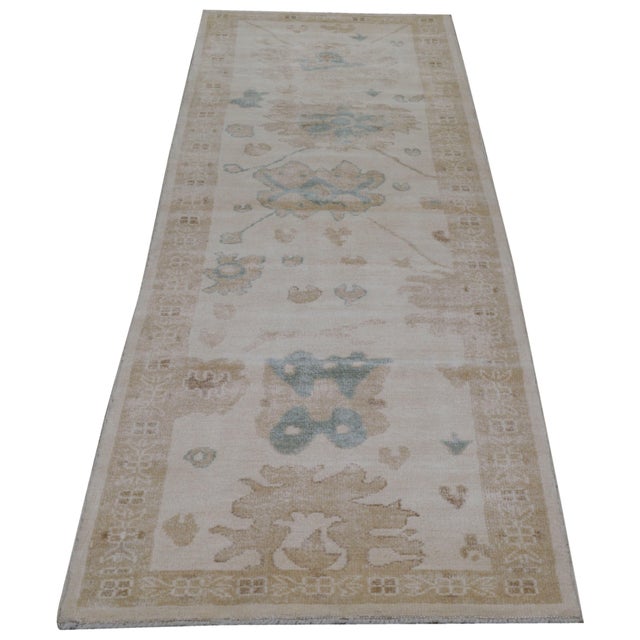 Hand-knotted with care using traditional rug making techniques, this wool rug blends timeless craftsmanship with a modern...