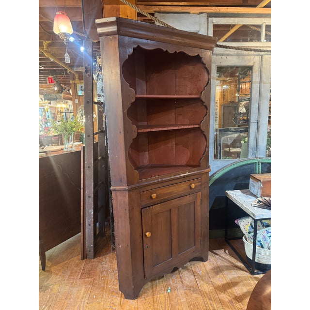 Large rustic wood corner cabinet with scallop details, open shelves with notches in wood shelf for displaying glassware....
