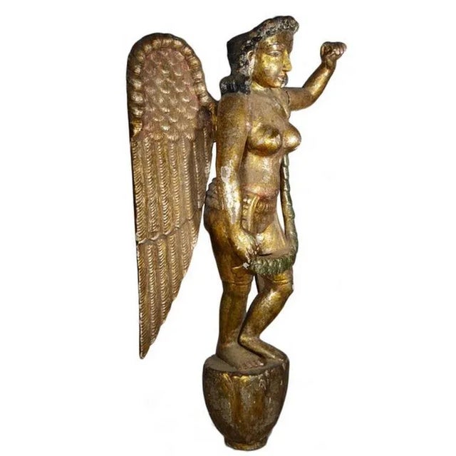 An Asian vintage giltwood hand-carved wooden female angel sculpture from the mid-20th century. This statue features an...