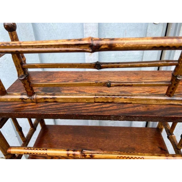 Antique bamboo etagere shelf stand. The Victorian era stand features a bamboo frame with four wood shelves. Around late...