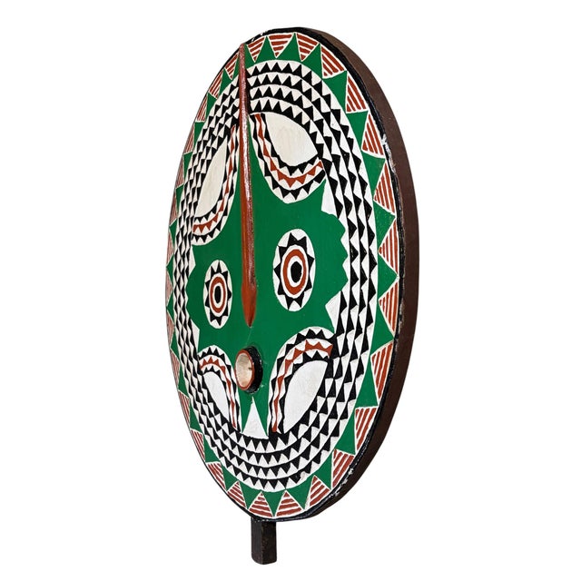 This striking vintage Bobo sun mask from Burkina Faso is hand-carved from wood and finished with an aged, multi-colored...