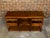 An English oak dresser base from the 19th century with marquetry, banding, doors and drawers. This 19th-century English...