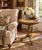 An elegant Regency-style flip-top side table in painted walnut, featuring hand-painted gold decoration against a soft...