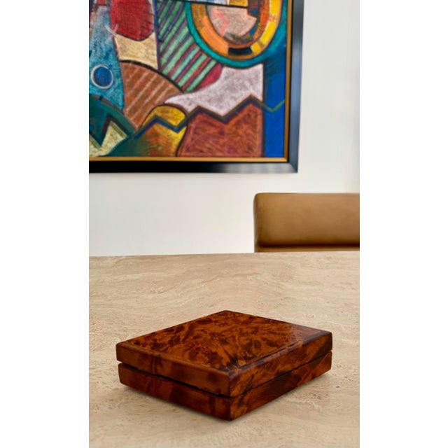 We are very pleased to offer this Italian burl wood box, circa 1950s, showcasing a richly dramatic swirling grain...
