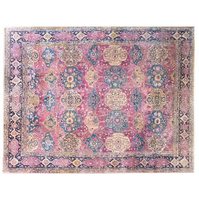 This magnificent late 19th-century Persian Lavar Kirman rug showcases an intricate all-over design of floral cartouches...