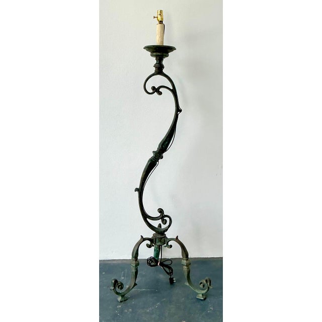 Illuminate your space with the timeless allure of this vintage bronze floor lamp, defined by its dramatic S-scroll...