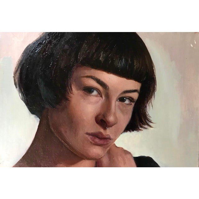 This oil on panel painting depicts a young woman with a striking bob haircut, her gaze direct and contemplative. The soft,...
