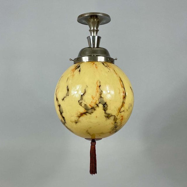 This art deco flush mount was designed any manufactured in germany in the 1920s to 1930s. The light features a spherical...