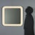 1970s wall mirror featuring a white plastic frame with rounded corners. This era-typical design combines functionality and...