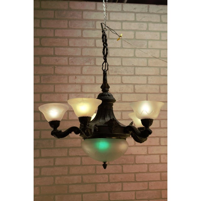 Antique Neoclassical Ornate Figural Bronze Northwind Faced 5 Arm Frosted Etched Glass Lamp Shade Chandelier Has a crack.