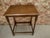 Charming vintage oak side table featuring classic barley-twist legs, a richly toned rectangular wood top, and traditional...