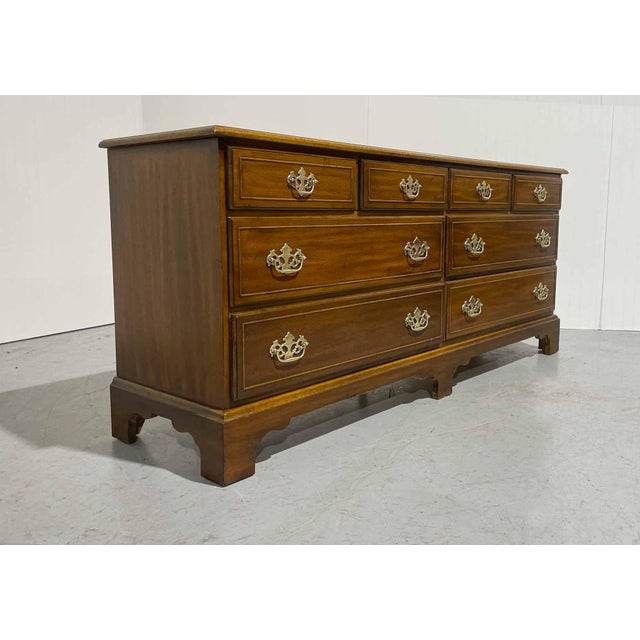 A traditional mid-century American-made dresser from the Hampton Court furniture line by Dixie Furniture.&nbsp;The solid...
