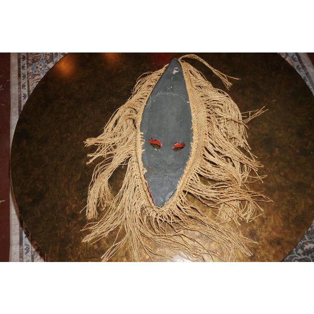 Hand-Painted Tribal-Style Wooden Mask With Natural Fiber Fringe – 18” For Sale - Image 4 of 4