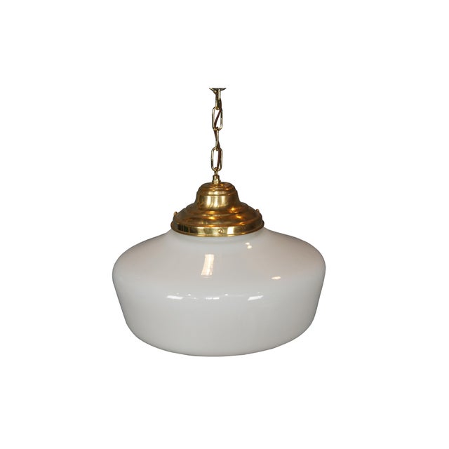 Vintage art deco style schoolhouse pendant light with brass caps and milk glass globe. Wired with plug. Dimensions: 15" x...