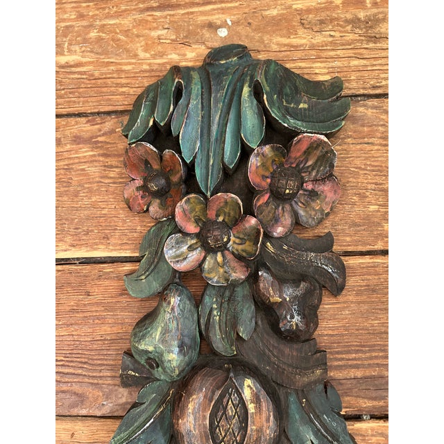 Lovely vintage pair of folk art hand carved wall swags having fruit and flowers.