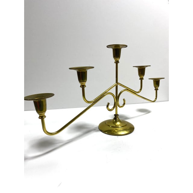A striking vintage brass candelabra with elegant arms and classic symmetry. Pieces like this create dramatic centerpieces...