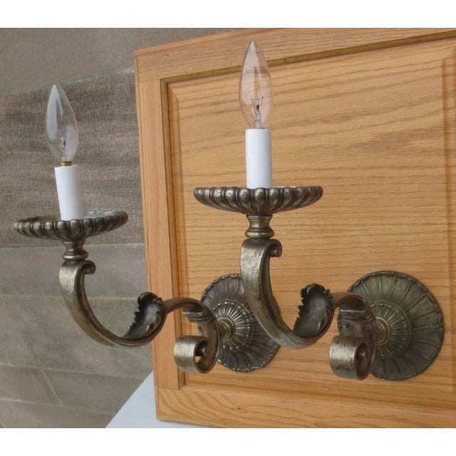 Vintage French 1950s" electrical sconces in the fashion of the Beaux Arts with Hurricane Glass shades. Cast bronze with...