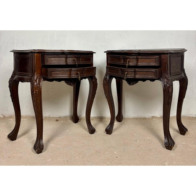 Elegant pair of Louis XV style nightstands featuring graceful bombe silhouettes, serpentine fronts, and finely carved...