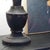 Antique-style metal table lamp with sculptural floral decoration and a black lampshade. Brand-new item with a design...