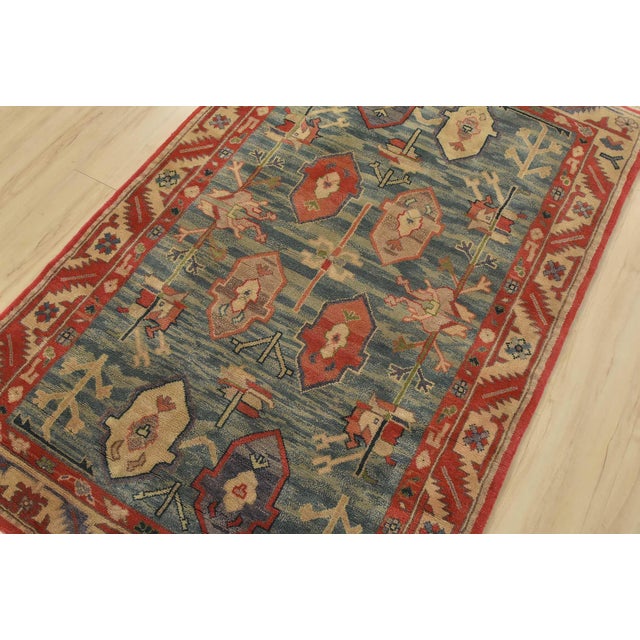 An authentic vintage tribal Heriz rug hand-knotted with fine wool on a cotton foundation. This rug features geometric...